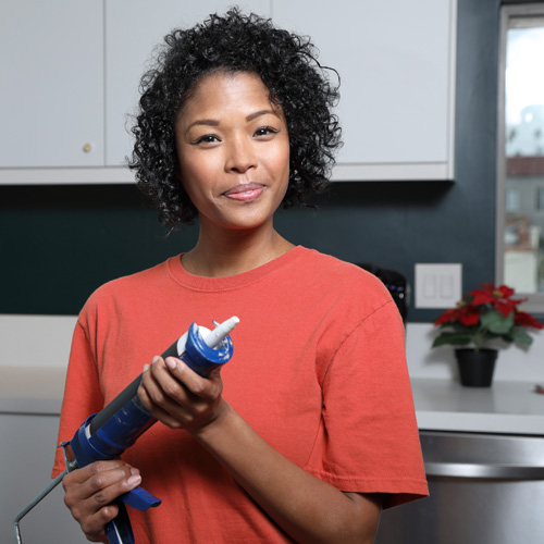 picture of woman with caulking gun